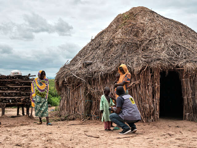 En RESCUE-medarbetare undersöker en liten pojke utanför familjens hem.