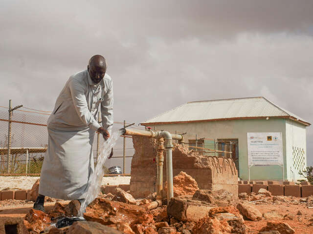Abdirashid Mohamed Hirsi testar en ny vattenpump som RESCUE har installerat.