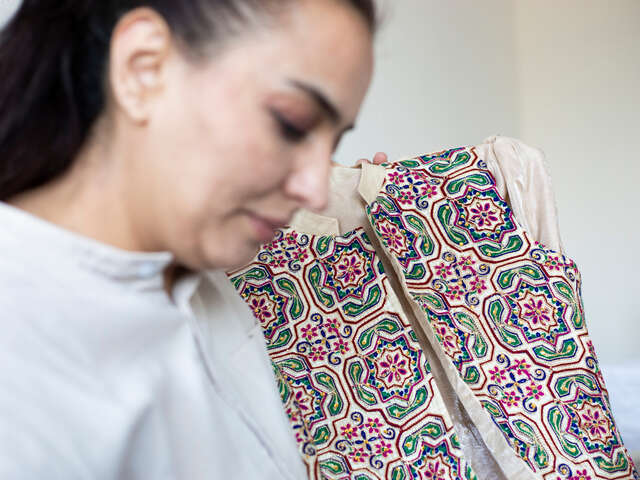 Bahar* is proudly showing a dress that she designed herself.