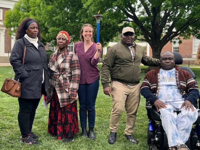 5 people standing together posing for photo