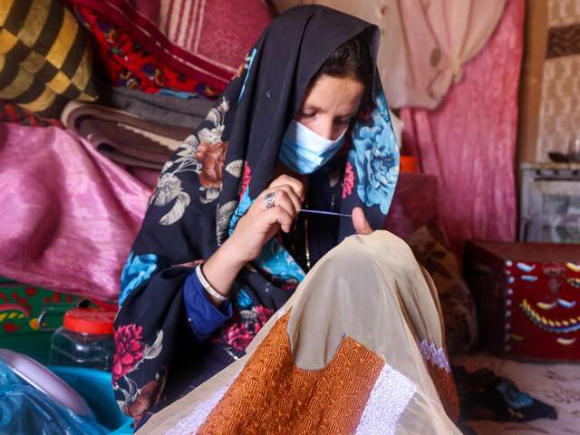 Afsana sells traditional Afghan hand embroidery at the marketplace to make ends meet. 