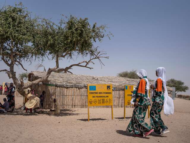 Yangou and Zara are walking to the Girlshine Center to take part in the day's activities. Girlshine was using the women’s safe spaces, while their center was damaged and being repaired by the IRC