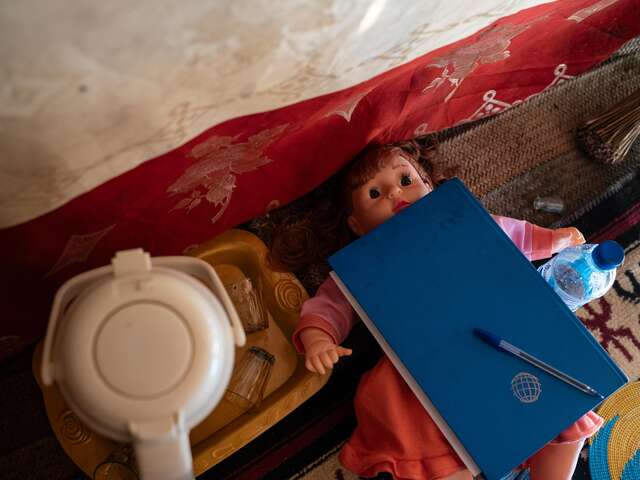 Bintou's notebook and doll at her home in Tagal. She uses the doll to demonstrate feeding practices to parents in her community.