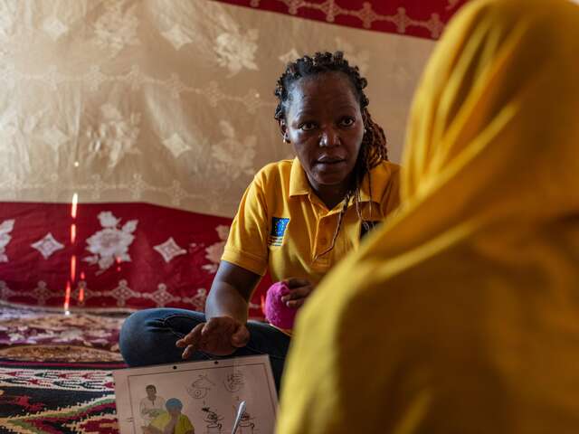 IRC officer Madjilem Sabine discusses facilitation skills with Bintou.