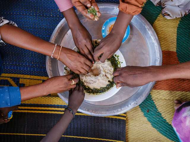 Zeinab and her friends dine together as they share local meal at her home in Farchana refugee camp.