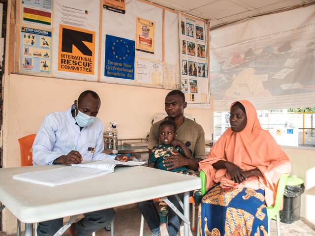 Kalil at a follow-up visit with Abubakar and his wife Zara at the IRC hospital in Hausari. Diagnosed with malaria, he has fully recovered after a blood transfusion donated by his father.