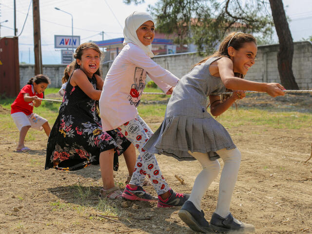 Four girls playing tug of war.