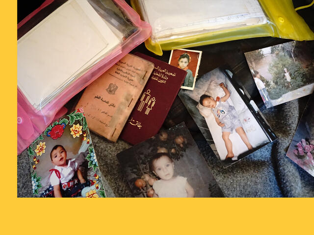 A pile of a refugees belongings including baby photographs