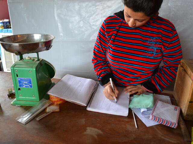 Diana logs transactions at her general store