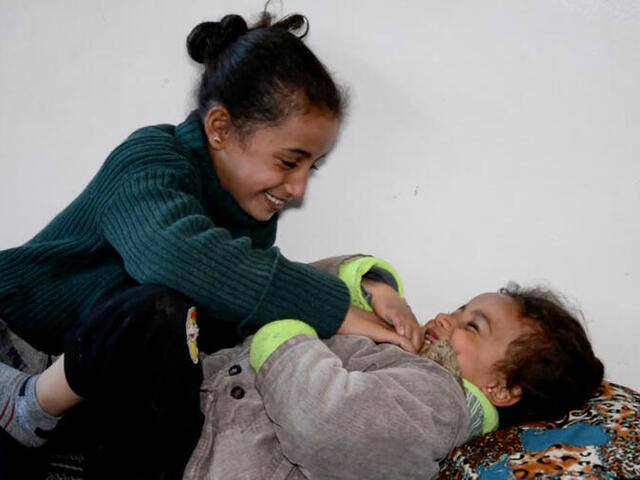 Reem playing with her sister.