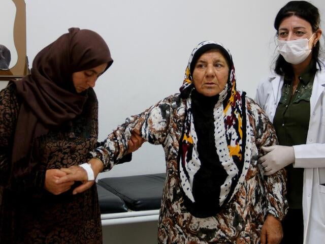 An elderly woman in Syria gets a health check.