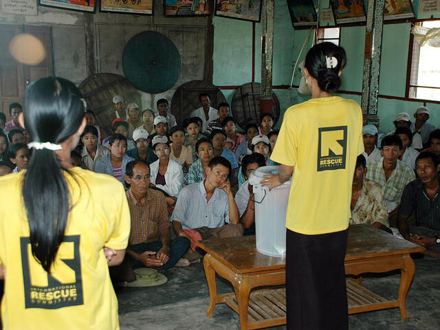 IRC staff talking to a room of seated people