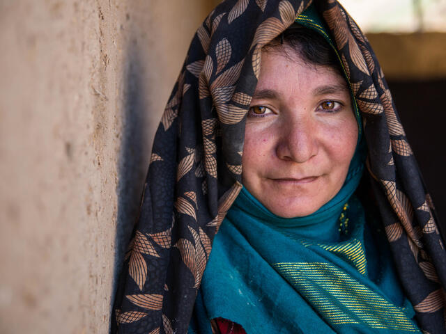 A woman looks into the camera.