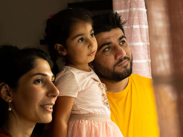 Maasom, Hiba and Nasrin look out the window together of their home in Hampshire.