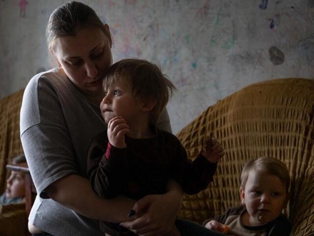 A woman holding a young child.