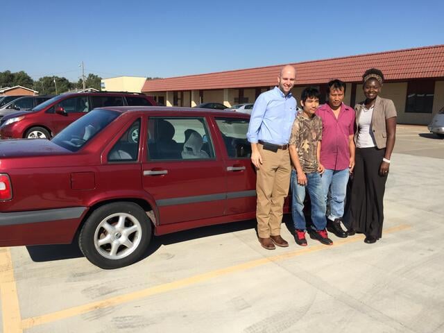 IRC staff member Amy Longa (right) with a refugee family who received a car donation