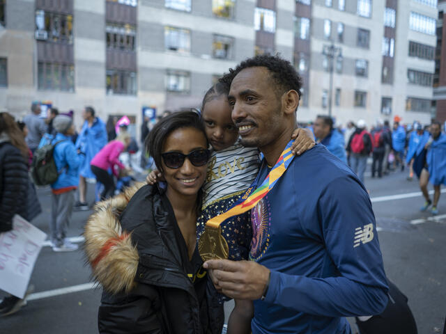 Tolassa Elemaa and his wife Bikiltu hold their daughter in Manhattan after the 2018 NYC Marathon