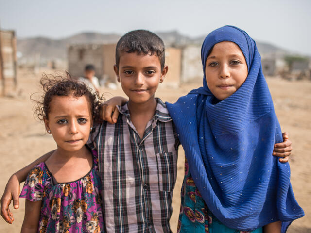 Children play with their friends in front of their home in Al Buraiqeh, a village on the outskirts of Aden, Yemen.