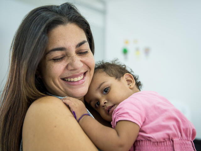 Andrea, 29, holds her sleepy one-year-old daughter