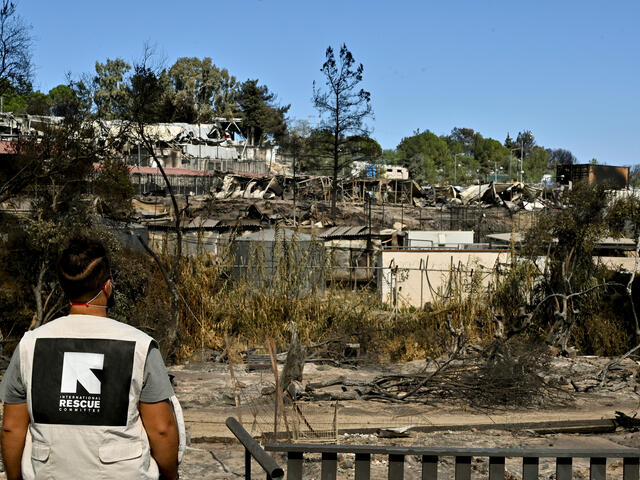 An IRC staff member views the remains of Moria refugee camp, destroyed by fire