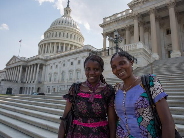 Séraphine Nsekanabo Musanga and Marie Jeannette Nabintu M’Mirindi stand together on the steps of the U.S. Capitol in Washington, D.C.