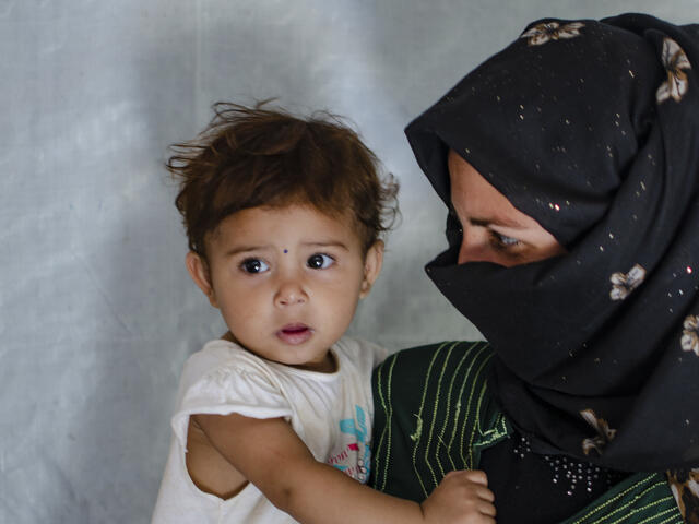 Syrian mother and refugee with her daughter in Lebanon 