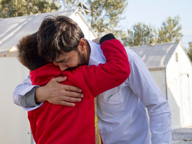 Afghan refugee father is reunited with his son.
