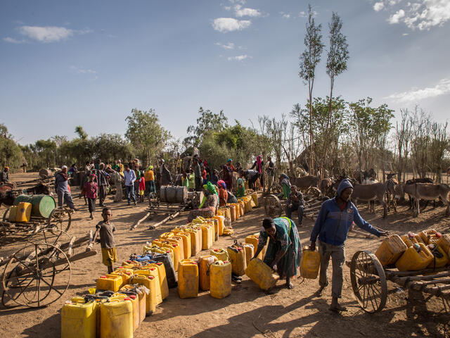 People line up to collect water