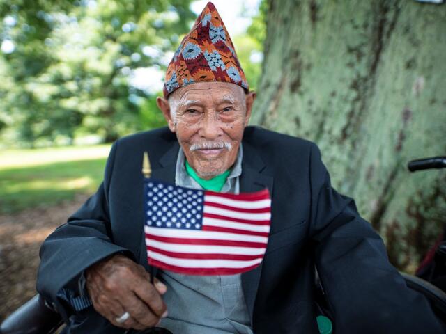 A man holds an American flag. 