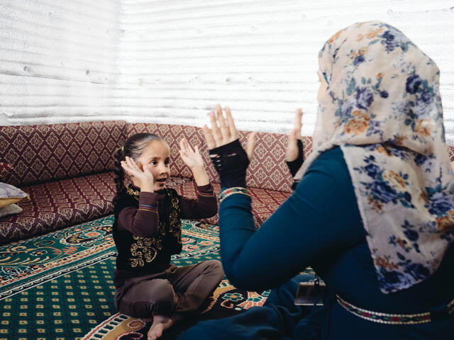Five-year-old Hiba plays with her mother, Hisina in their home in Azraq camp in Jordan