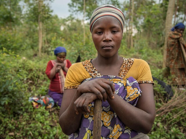 Women with farming implements work the land in the Democratic Republic of Congo.