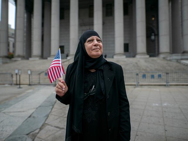 Maha, 66, a former Iraqi refugee, stands outside the federal building in lower Manhattan, after she passes her U.S. citizenship exam.