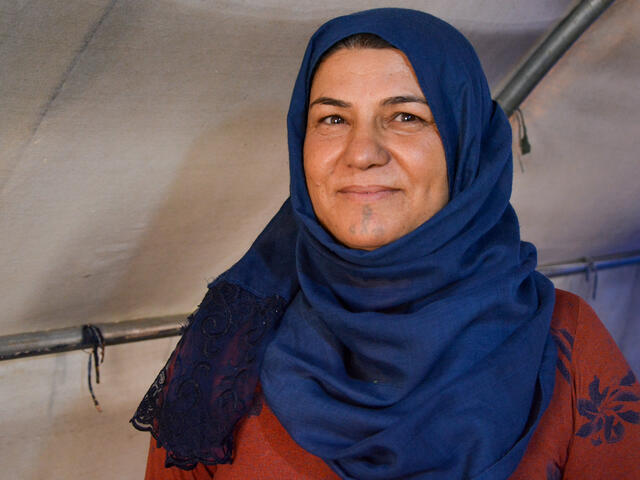 A Syrian woman smiles.