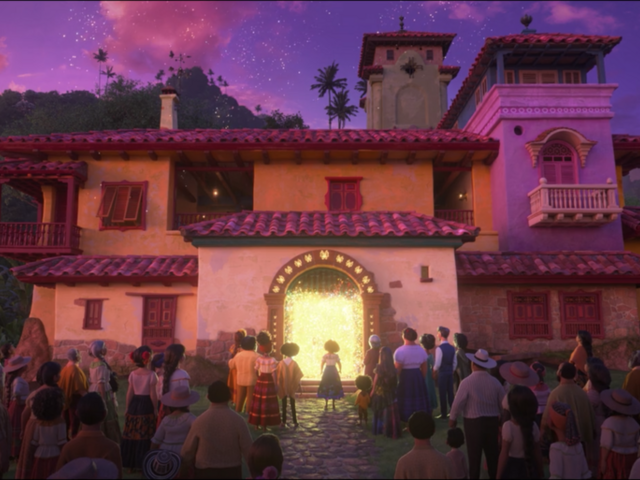 The magical castia, in purple and pinks, with a glow coming from the front door. Mirabel is standing in front of the door and her whole family and the whole town stands behind her. 
