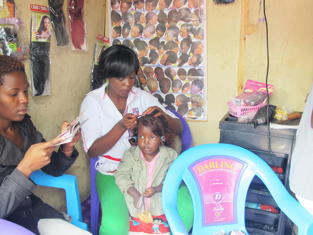 Susan braids a girl's hair