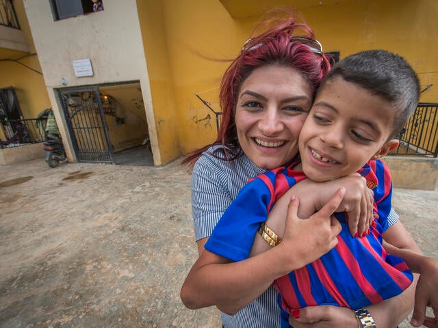 Roushan Khalaf with a refugee child in Bebnine, Lebanon