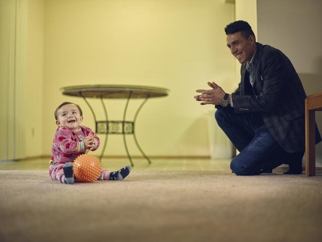 Adil with his son Steven inside their apartment