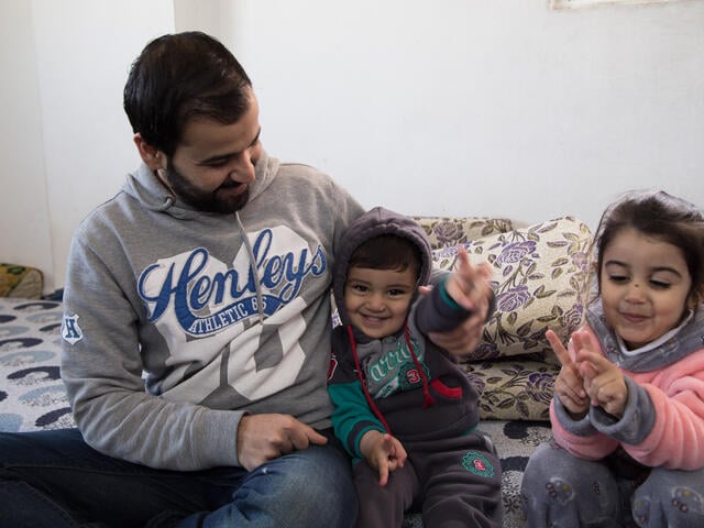 Mohammed with his son Khaled in their home in Irbid, Jordan