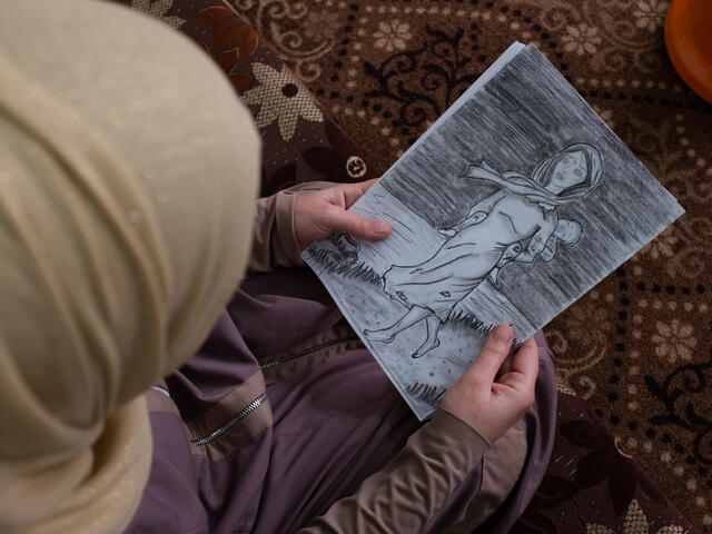 Syrian woman with a drawing 