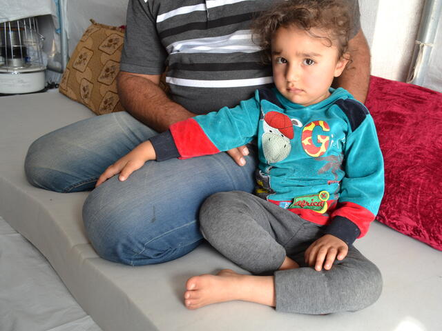 Khaled with his three-year-old daughter at the Khazer displacement camp
