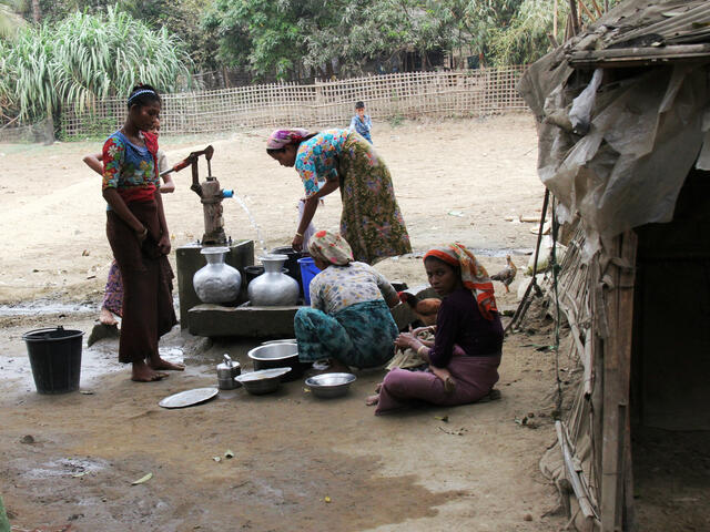 Women pump water at a camp in Sittwe, Myanmar