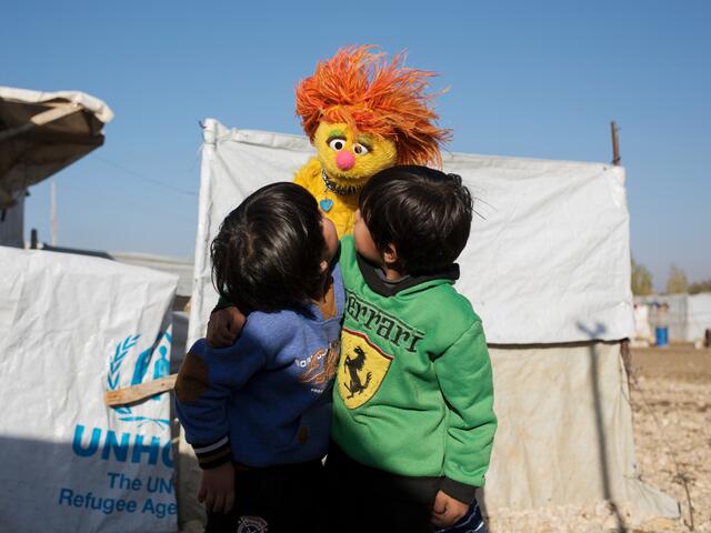 Syrian boys play with Sesame Street Muppet Tonton