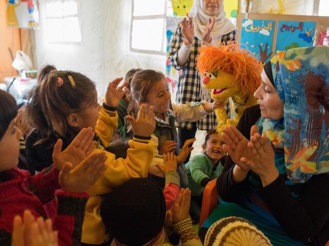 Syrian children with Sesame Street Muppet Tonton