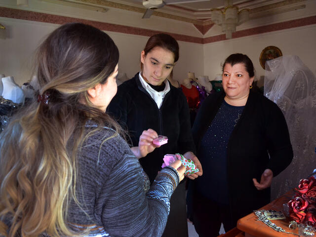 Linda and her 16-year-old daughter Mimi  talk to a customer.