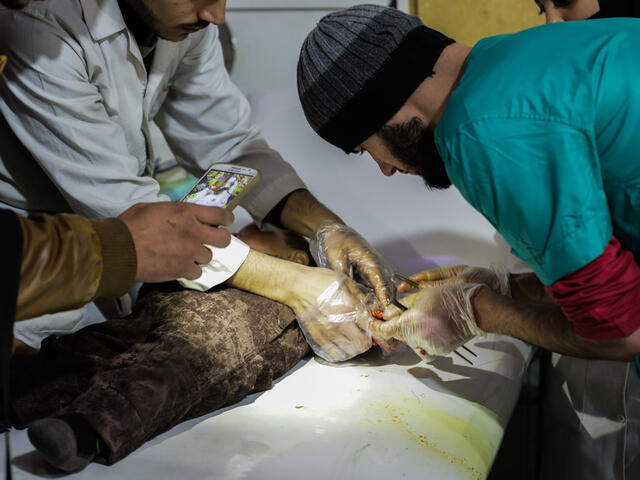 A doctor who works at a hospital in Eastern Ghouta treats a toddler's wounds