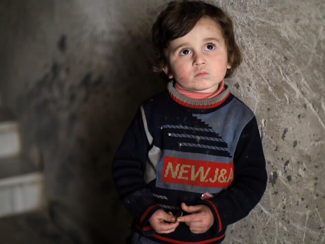 Syrian boy in underground bunker by the stairs