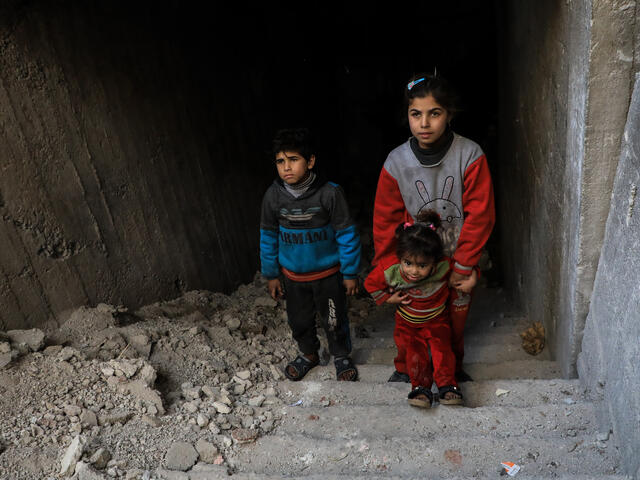 Syrian children climb from their underground bunker in Eastern Ghouta