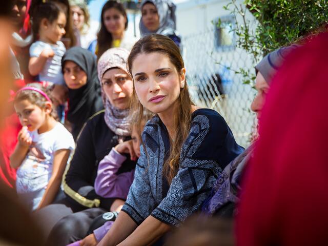 Queen Rania Al Abdullah of Jordan listens to refugee women at a refugee camp in Greece