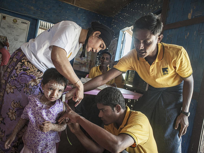 IRC health workers examine a child in a clinic in Rakhine State, Myanmar IRC health workers examine a child in a medical clinic in Rakhine State