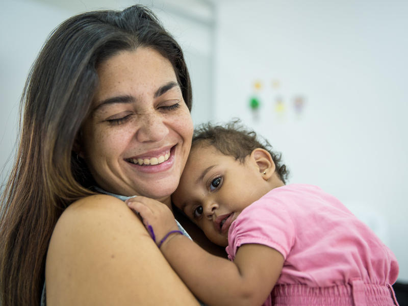 Andrea, 29, holds her sleepy one-year-old daughter